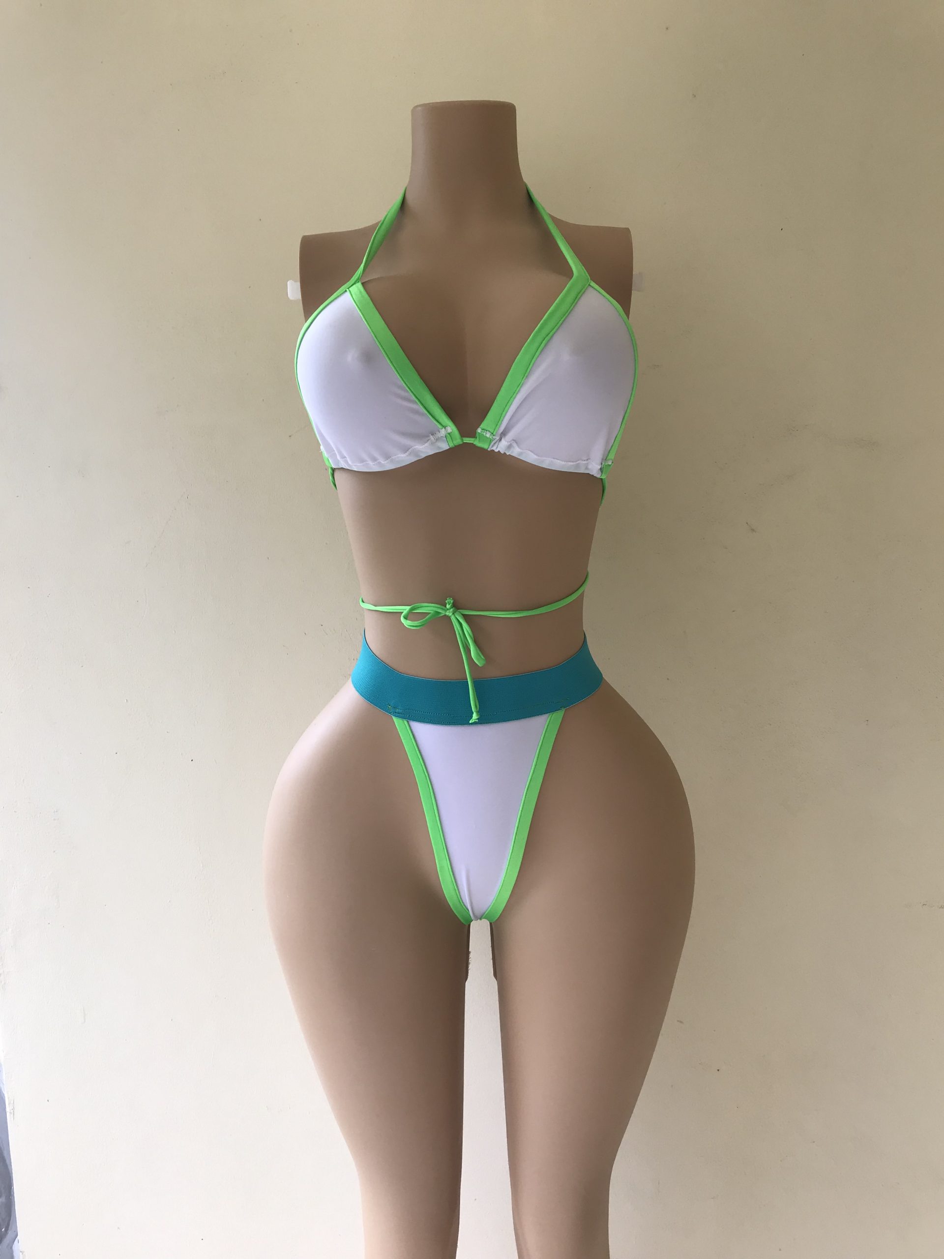 Lightning bikini in white with neon green trim and turquoise waistband – front view on mannequin