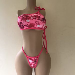 Siren. A one-shoulder floral bikini with thong bottom and hot-pink trim – front view on mannequin