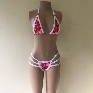 Seduction. A bikini in pink floral print with strappy thong bottom and silver ring details – front view on mannequin