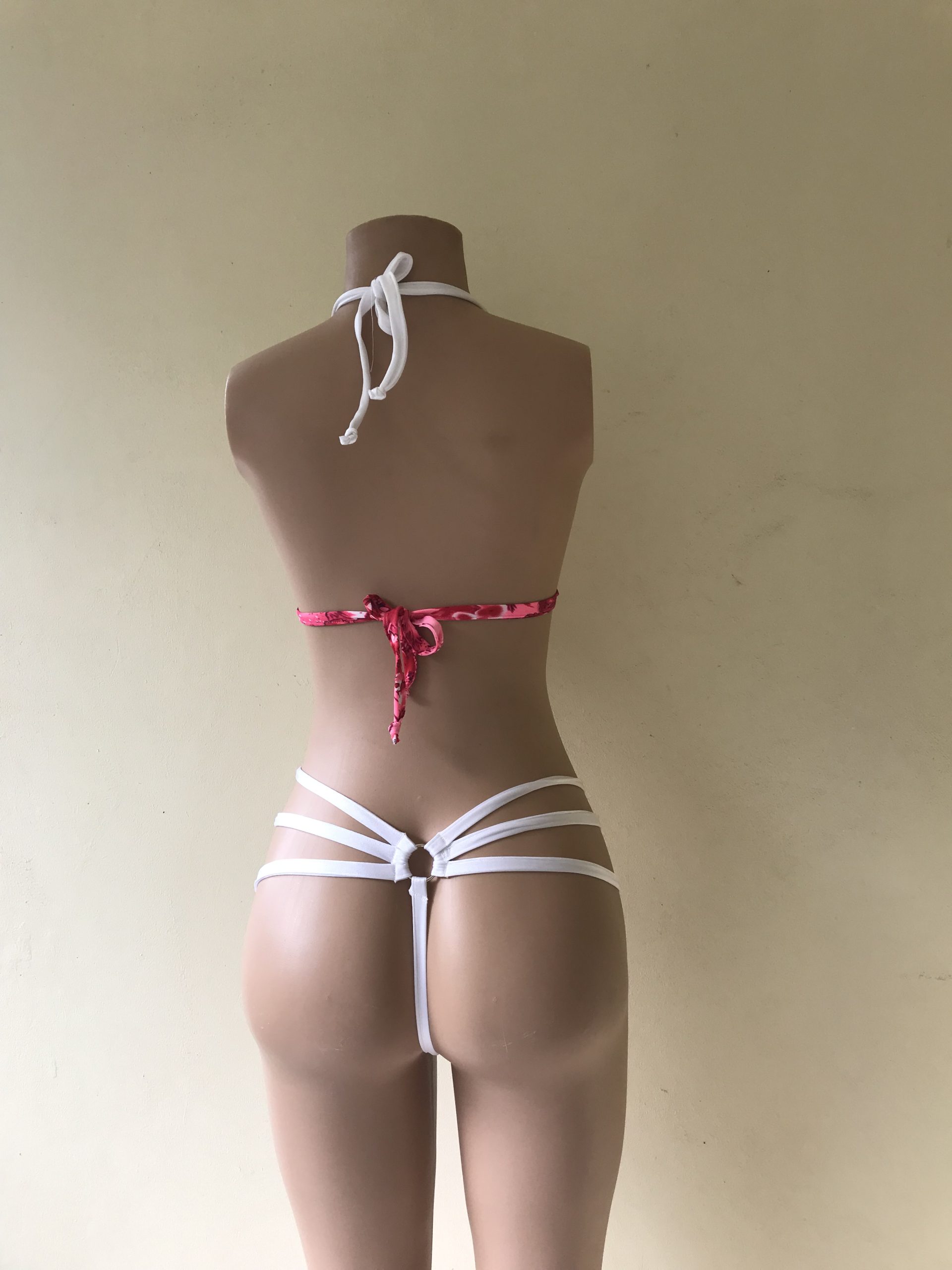 Seduction. A bikini in pink floral print with triple strap thong back and silver ring detail – back view on mannequin