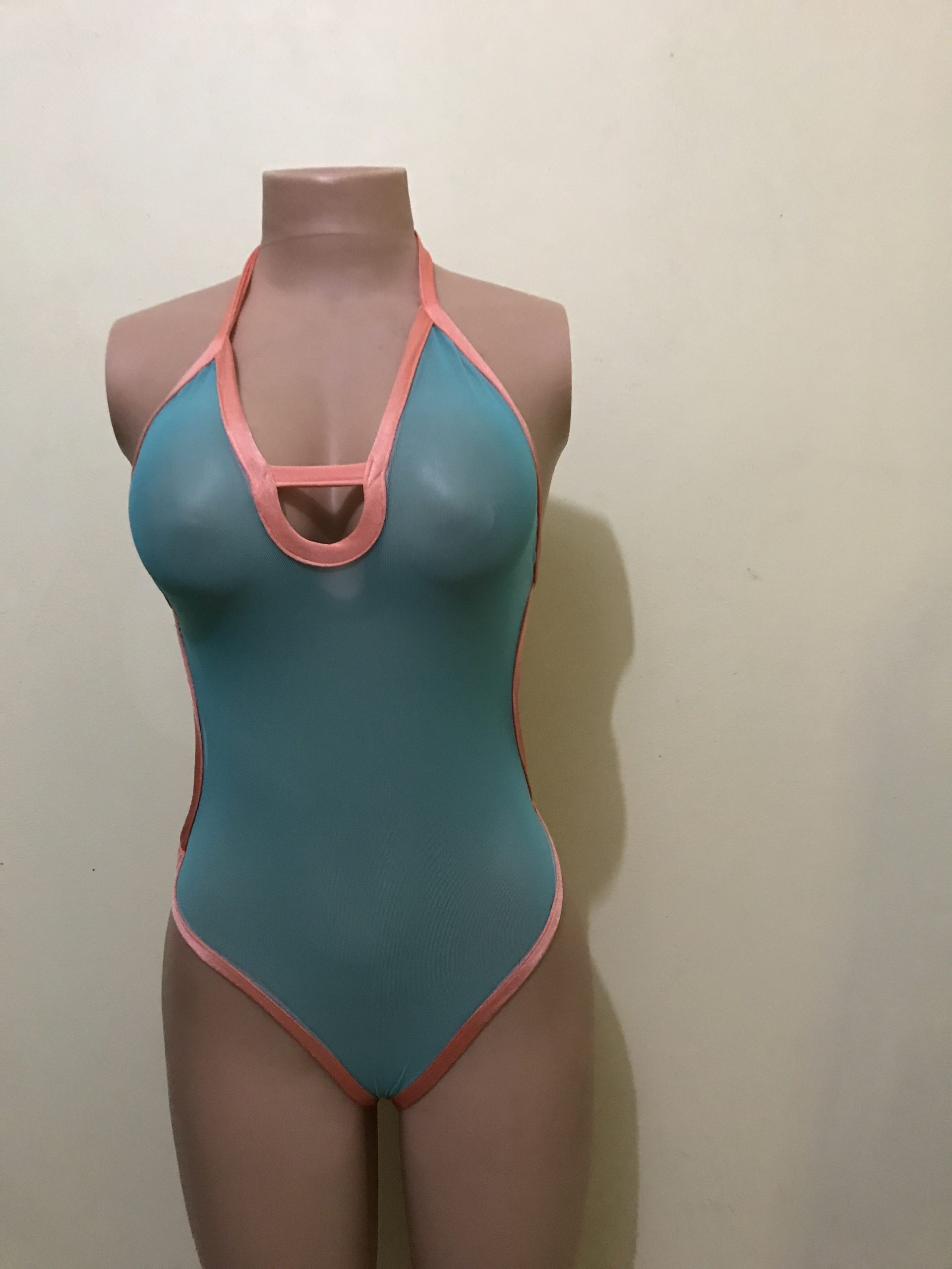Aqua and coral halter monokini with keyhole cutout, front view on mannequin