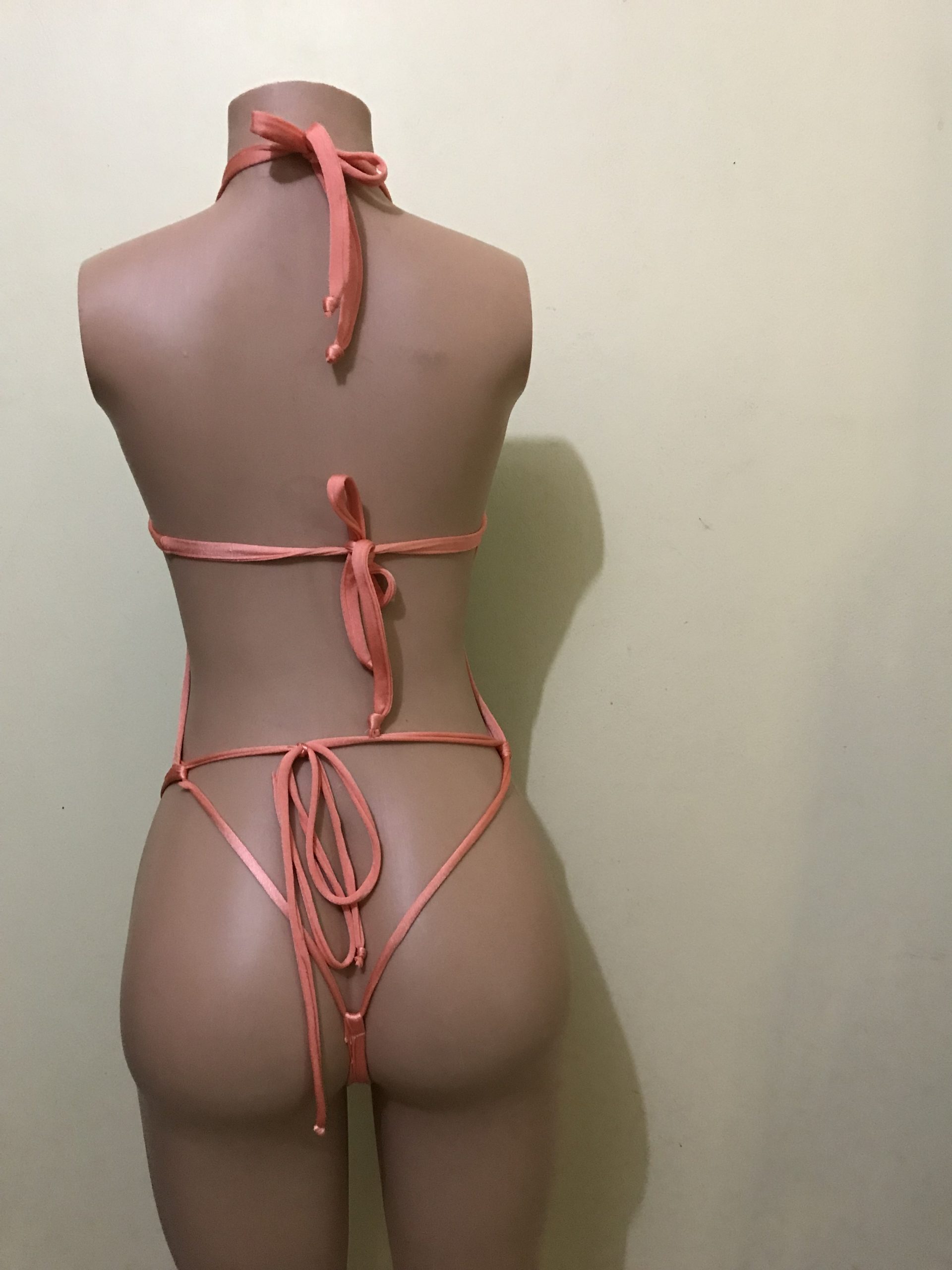 Aqua and coral halter monokini with strappy tie back and thong cut, back view on