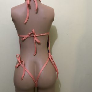 Multicolor star-print monokini with coral straps and thong cut, back view on mannequin